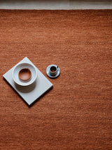 Armadillo Cable Rug in Bisque, a second view of the handwoven soumak wool rug in a styled interior