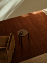 Armadillo Thatch Rug in Copper, hand-knotted wool rug shown in a room setting