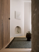 Armadillo Willow Rug in Cypress, handwoven flatweave rug shown in a room setting