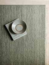 Armadillo Cable Rug in Jade, a second view of the handwoven soumak wool rug in a styled interior