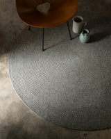 Armadillo Braid Rug in Heron, a second view of the hand-braided wool blend rug in a styled interior