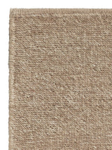 Armadillo Aspen Rug in Sandstorm, corner close-up of the undyed wool pile and edge