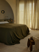 Armadillo Selva Rug in Oat, handwoven afghan wool kilim rug shown in a room setting