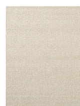 Armadillo Pebble Rug in Tofu, corner close-up of the hand-spun new zealand wool pile and edge