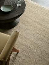 Armadillo Mojave Rug in Cashew, hand-knotted jute rug shown in a room setting