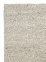 Armadillo Aspen Rug in Fog, corner close-up of the undyed wool pile and edge