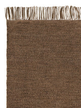 Armadillo Willow Rug in Cumin, corner close-up of the linen, wool, and jute pile and edge