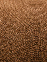 Armadillo Braid Rug in Persimmon, overhead view of the hand-braided wool blend weave and edge finish