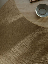 Armadillo Nimbus Rug in Wasabi, a second view of the hand-braided new zealand wool rug in a styled interior