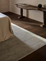 Armadillo Thatch Rug in Concrete, hand-knotted wool rug shown in a room setting