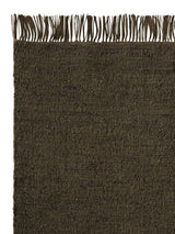Armadillo Willow Rug in Cypress, corner close-up of the linen, wool, and jute pile and edge