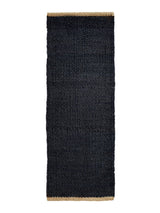 Armadillo Nest Nook Rug in Charcoal, a second view of the handwoven jute flatweave rug in a styled interior