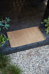 Armadillo Nest Nook Rug in Natural, handwoven jute flatweave rug shown in a room setting