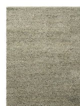 Armadillo Meadow Rug in Pistachio, corner close-up of the wool pile and edge