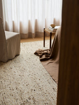 Armadillo Faroe Rug in Foal, a second view of the hand-knotted undyed wool rug in a styled interior