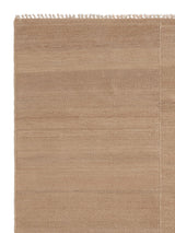 Armadillo Selva Rug in Desert, corner close-up of the afghan wool pile and edge