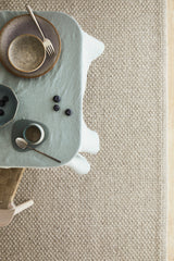 Armadillo Winnow Rug in Granite, a second view of the handwoven wool flatweave rug in a styled interior