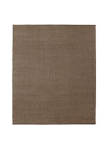 Armadillo Palloza Rug in Shale, a second view of the handwoven jute flatweave rug in a styled interior