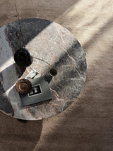 Armadillo Petra Rug in Sparrow, a second view of the hand-knotted new zealand wool rug in a styled interior