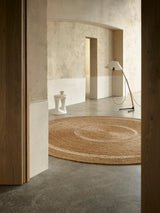 Armadillo Petunia Rug in Natural, hand-braided jute rug shown in a room setting