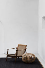 Nest Rug by Armadillo, handwoven jute flatweave rug, styled in a room at Calimia Home