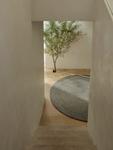 Armadillo Nimbus Rug in Oakmoss, detail of the hand-spun new zealand wool with jute stitching weave and texture