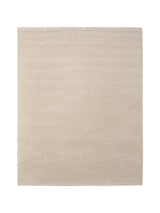 Armadillo Marea Rug in Vellum, a second view of the hand-knotted and hand-carved wool rug in a styled interior