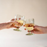 Hand-blown recycled glass wine glass with soft curves and airy bubbles