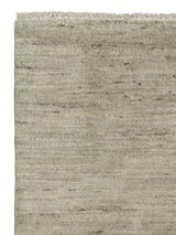 Armadillo Odessa Rug in Travertine, corner close-up of the afghan wool pile and edge
