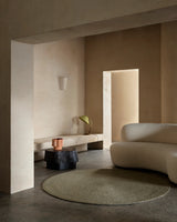 Armadillo Braid Rug in Oregano, hand-braided wool blend rug shown in a room setting