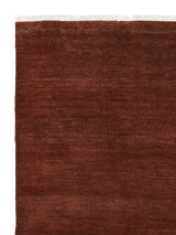 Armadillo Agra Rug in Burnt Umber, corner close-up of the wool pile and edge