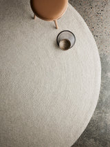 Armadillo Braid Rug in Chalk, a second view of the hand-braided wool blend rug in a styled interior