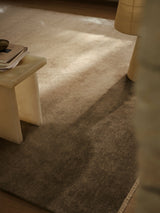 Armadillo Corsica Rug in Flannel, a second view of the handwoven wool and linen rug in a styled interior