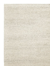 Armadillo Aspen Rug in Natural, corner close-up of the undyed wool pile and edge
