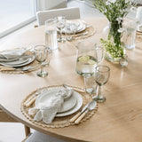 Be Home Ruffle Glass Pitcher filled with water and lemon slices on a beautifully set wooden dining table.