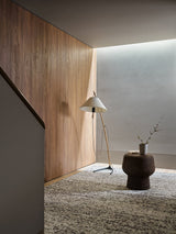 Armadillo Faroe Rug in Muscovado, a second view of the hand-knotted undyed wool rug in a styled interior