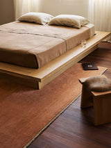 Armadillo Agra Rug in Salmon, a second view of the hand-knotted wool rug in a styled interior