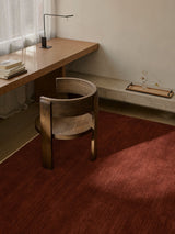 Armadillo Agra Rug in Burnt Umber, hand-knotted wool rug shown in a room setting