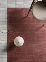 Armadillo Agra Rug in Redwood, overhead view of the hand-knotted wool weave and edge finish