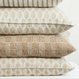 Walter G Aravelli Shell Pillow stack featuring hand block-printed beige and tan patterns with piped edges.