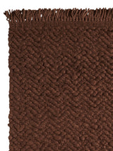 Armadillo Arroyo Rug in Tamarind, corner close-up of the felted wool pile and edge