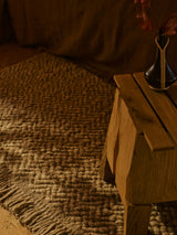 Armadillo Arroyo Rug in Sepia, a second view of the handwoven felted wool rug in a styled interior