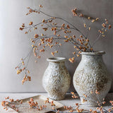 Artificial Oriental Bittersweet Berry stems by Abigail Ahern arranged in two textured stone vases