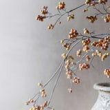 Arching Artificial Oriental Bittersweet Berry branch by Abigail Ahern against a soft gray wall