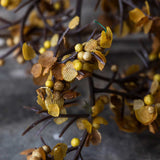 Close-up of Artificial Sedge Winter Saffron by Abigail Ahern showing its saffron and golden clusters