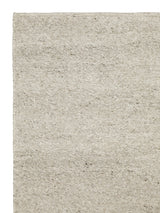 Armadillo Aspen Rug in Fog, corner close-up of the undyed wool pile and edge
