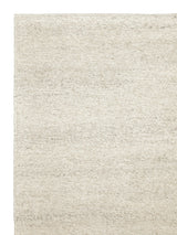 Armadillo Aspen Rug in Natural, corner close-up of the undyed wool pile and edge