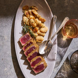 Bianco Assisi oval platter styled on a dinner table