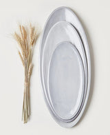 Three sizes of the Bianco Assisi oval platter