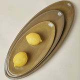 Ochre Assisi oval platter styled on a dinner table